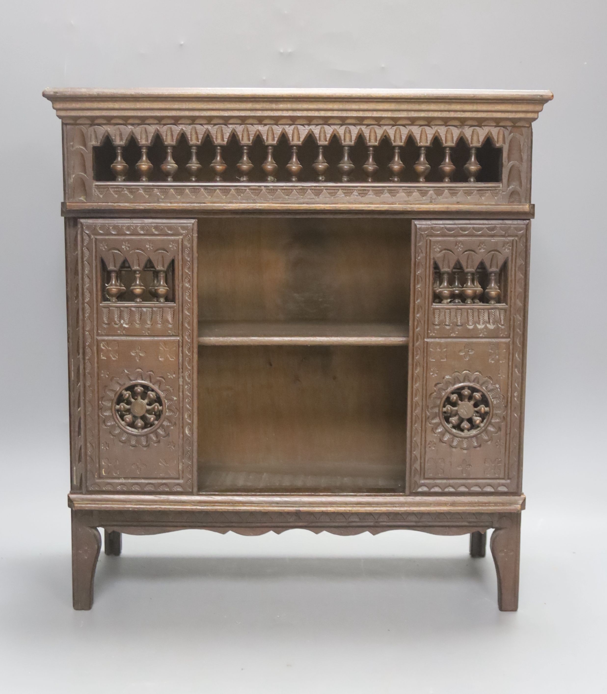 A 19th century French miniature carved oak cupboard with sliding doors. 37cm